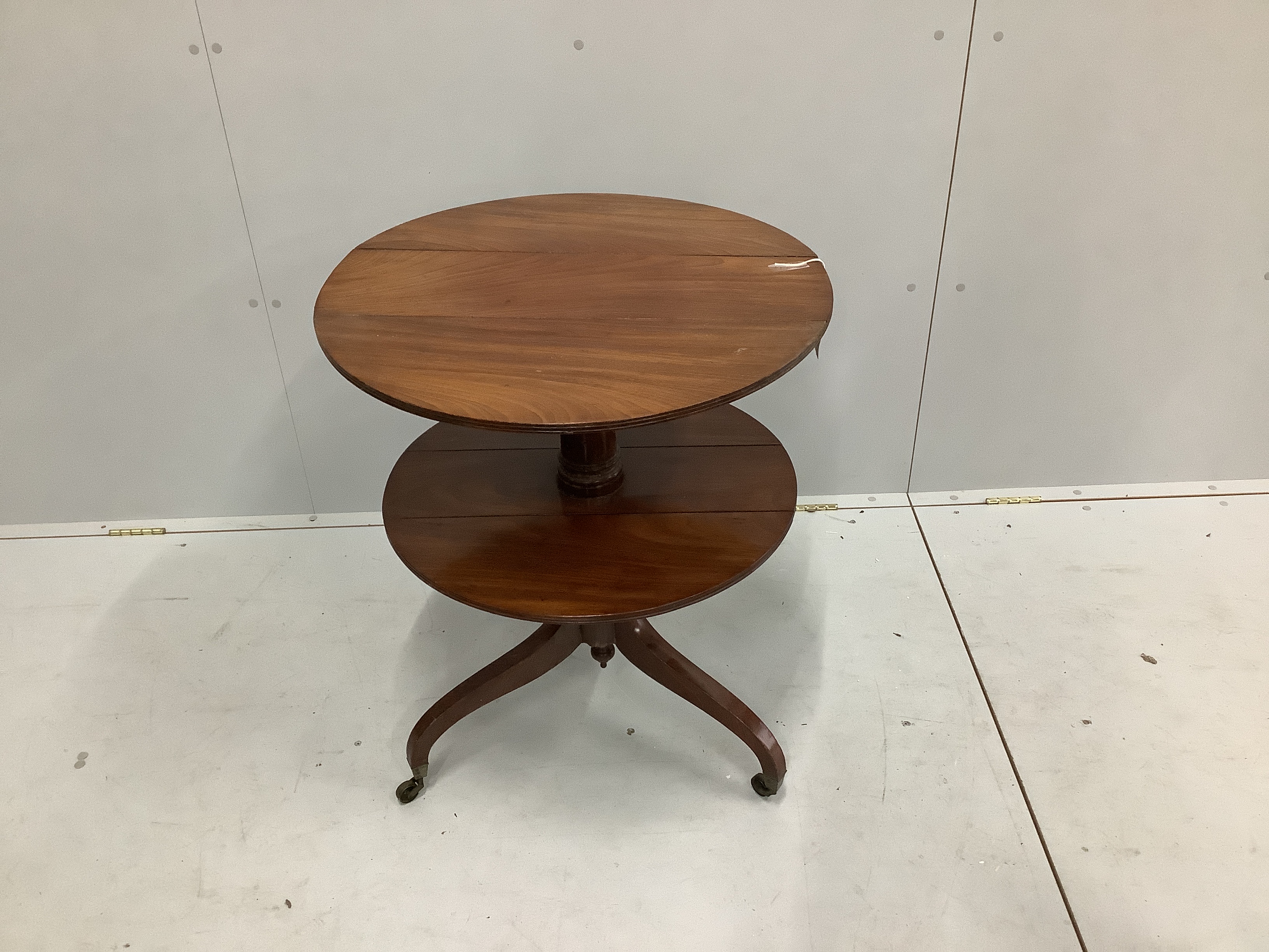 A Regency circular mahogany two tier drop flap occasional table, diameter 63cm, height 76cm